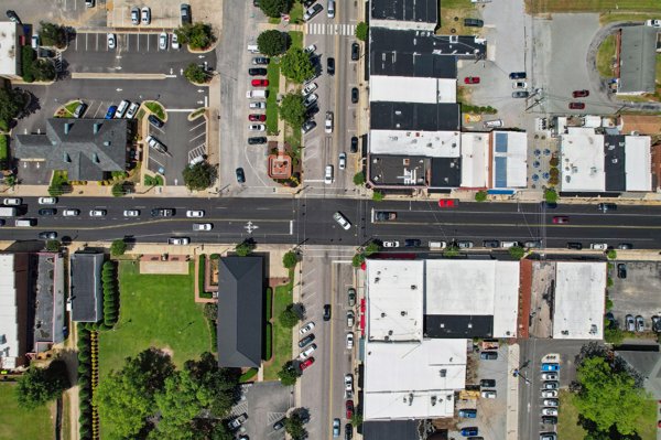 Top-down aerial view of an intersection in downtown Angier, North Carolina highlighting streets, buildings, and parking areas.