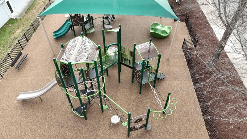 Aerial view of modern playground with climbing structures and slides in Clayton NC