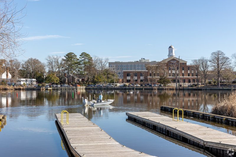 An aerial view of the New River, bridges, and downtown waterfront in Jacksonville, NC.