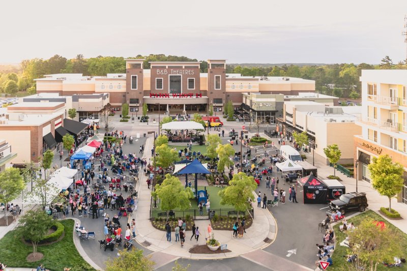 Aerial view of Park West Village in Morrisville, North Carolina with outdoor lawn event and B&B Theatres