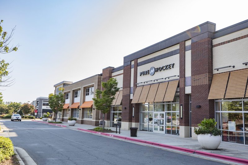 Retail shopping streetscape at Park West Village in Morrisville, North Carolina with storefronts and sidewalks