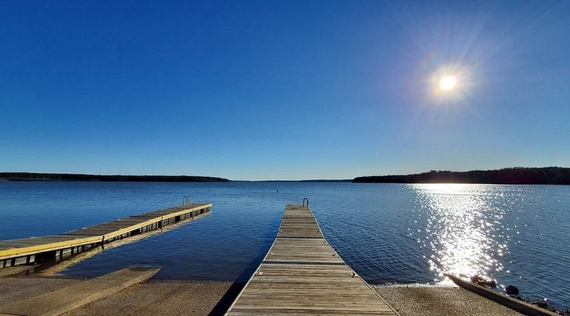 Dock and lake view at Jordan Lake near Pittsboro, North Carolina with sunlight reflecting on water