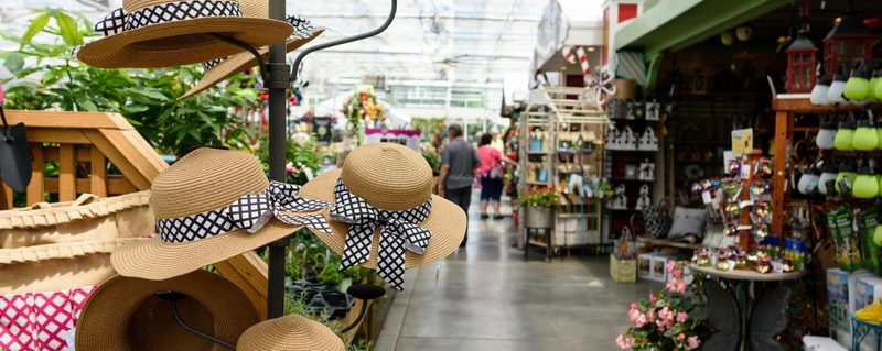 Interior of a garden center market with hats, plants, and decor items on display in Selma, North Carolina.