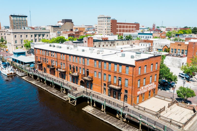 Historic brick building along the Wilmington Riverwalk waterfront in Wilmington, NC.