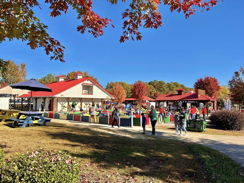 Hill Ridge Farms outdoor activity area with families enjoying attractions in Youngsville, North Carolina.